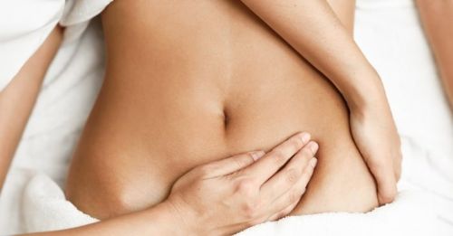 Lymphatic drainage massage on the abdomen using oils