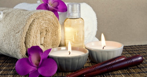 Tatami mat massage setup with candles and bamboo screen